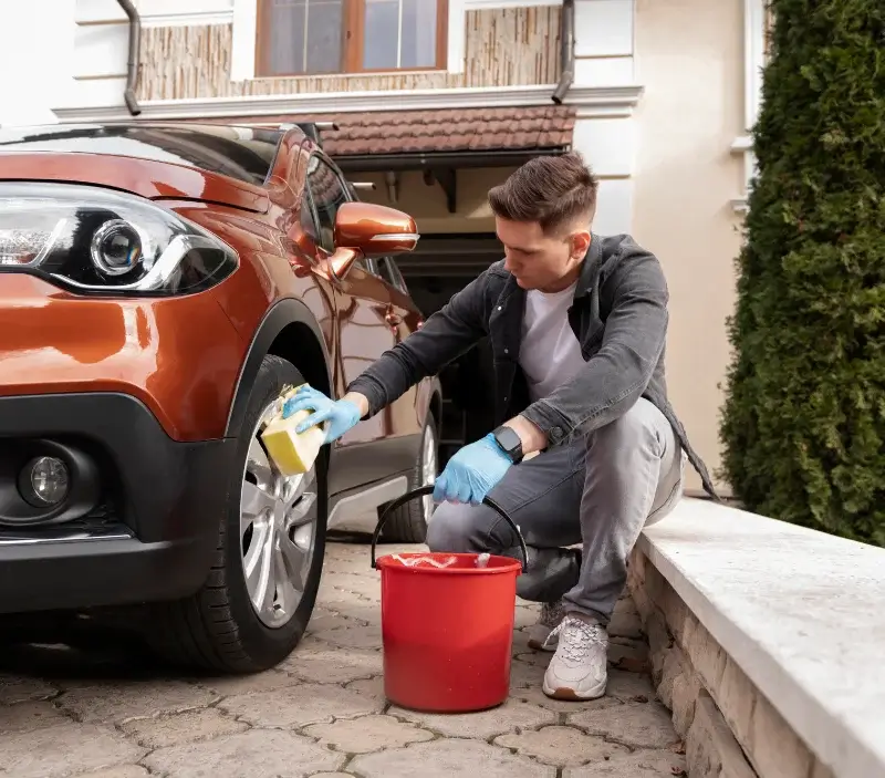 Lavage auto à domicile Saint-Cyr-en-Pail : professionnel intervenant sur un véhicule